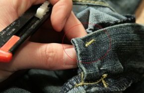 7) Now we need to free up the backside of the zipper so we can close the bottom. On the inside of the garment,  use a seam ripper or razor to cut the tack the holds together the placket layers.